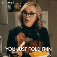 Iconic scene from Schitt's Creek where David and Moira debate how to fold it in, relevant to wishing we could just fold in our Universal Analytics data