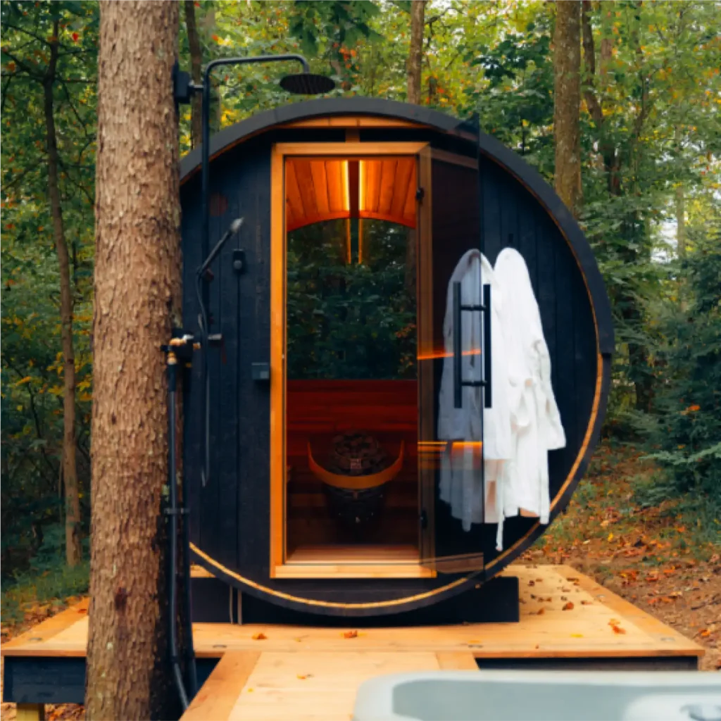 Black ignite barrel sauna in the woods