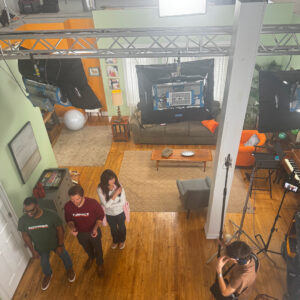 Behind the scenes of a commercial shoot. Overhead view of the set with multiple actors waiting for direction.